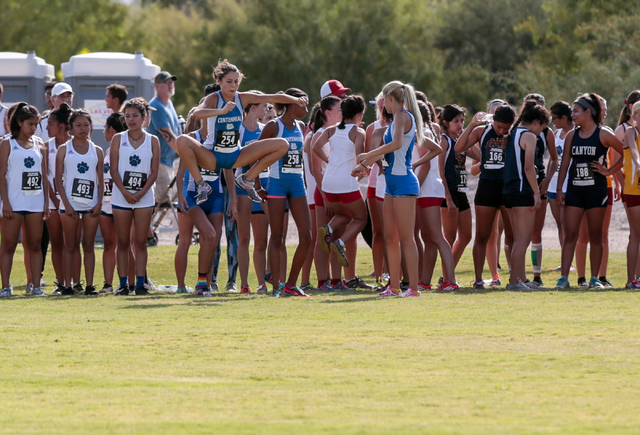 Cross country varsity girl runners warm up prior to their race at the 2016 Larry Burgess Cro ...