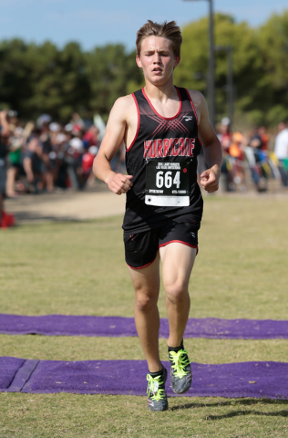 Hurricane’s Caleb Armstrong (664) runs across the finish line for a win in the varsity ...