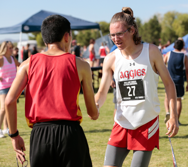 Arbor View junior and cross country runner Ian Jackson (27), right, congratulates another r ...