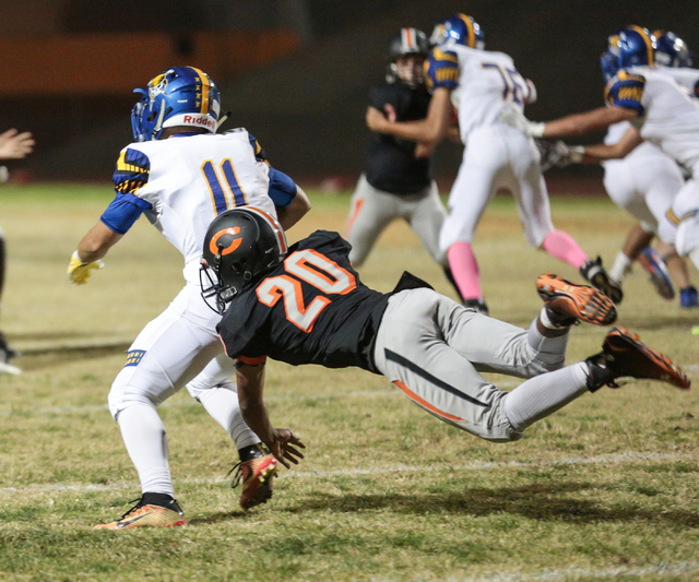 Chaparral junior Dylan Disroe (20) attempts to bring down Moapa Valley sophomore Braeden St ...