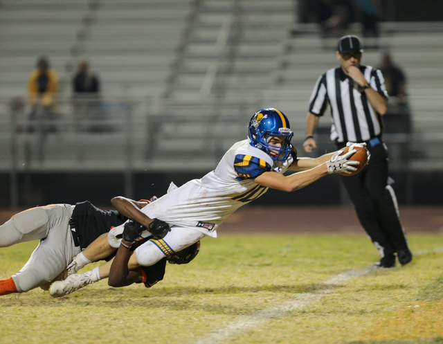 Moapa Valley senior Dayton Wolfley (10) stretches out with the ball over the goal line for a ...