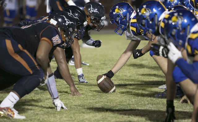 Legacy High, left, and Moapa Valley players face off during a varsity football game at Legac ...