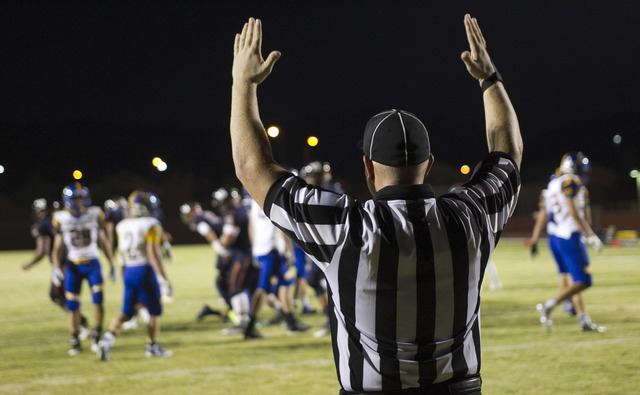 A referee calls a point during the Legacy High and Moapa Valley varsity football game at Leg ...