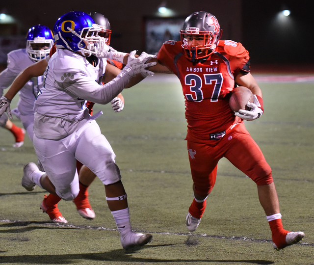 Arbor View’s Lorenzo Mationg (37) runs the ball against Orem’s defense during th ...