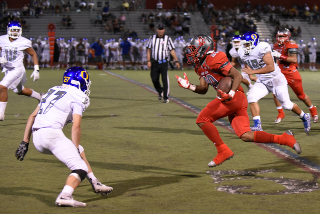 Arbor View’s Jaquari Hannie (20) runs the ball against Orem’s defense during the ...