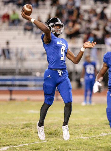 Desert Pines quarterback Randal Grimes (9) prepares to release the ball to a receiver downfi ...