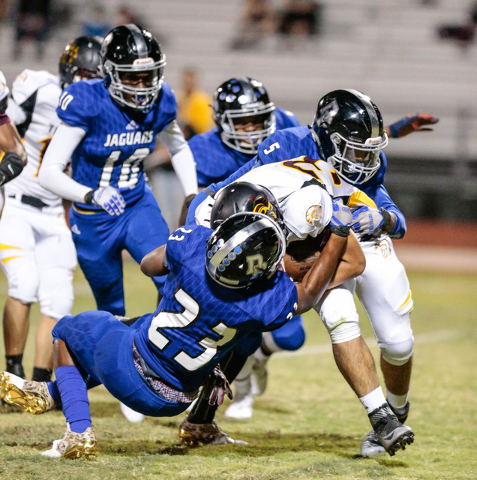 Desert Pines senior Trez’men Culpepper (23) and Desert Pines senior Eddie Heckard (5) ...