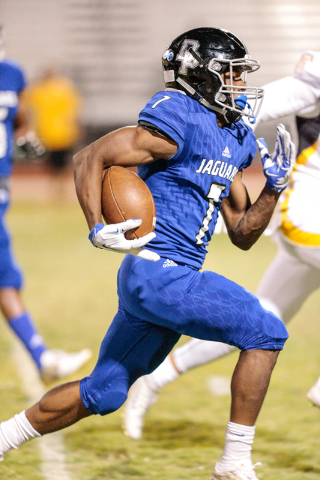 Desert Pines senior Isaiah Morris (7) moves the ball up field during a football matchup agai ...