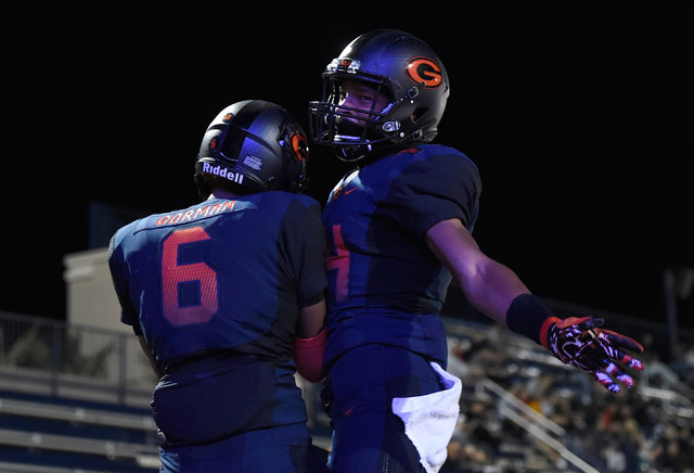 Bishop Gorman’s Austin Arnold (6) and Dorian Thompson-Robinson celebrate a touchdown a ...