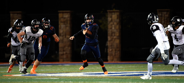 Bishop Gorman quarterback Tate Martell runs with the ball against Palo Verde during the firs ...