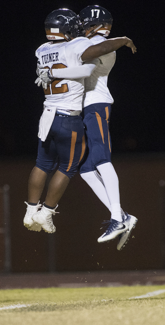 Legacy High School players Samuel Turner (22) and Davick Clark (17) celebrate a touchdown du ...