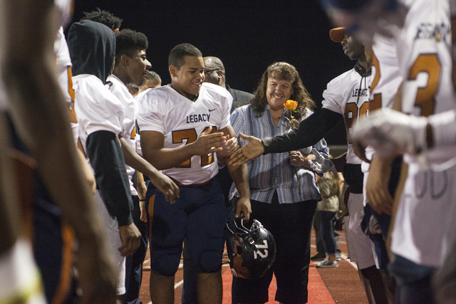Noah Jefferson and his mom Dawn Jefferson are greeted by the other Legacy High School player ...