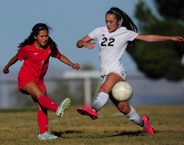 Arbor View midfielder Sierra Vicente, left, passes the ball while being challenged by Palo V ...