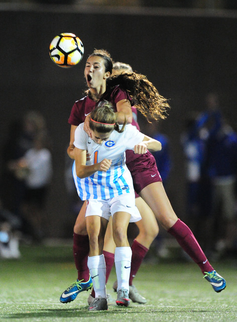 Desert Oasis forward Adriana Gonzalez and Bishop Gorman defender Jaden Terrana (1) go up for ...