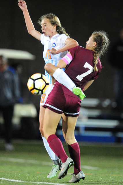 Bishop Gorman midfielderTaylor Cox (18) and Desert Oasis defender Cayla Lee (7) fight for th ...