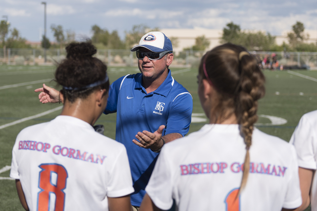 Bishop Gorman’s girls soccer coach Doug Borgel speaks with his team during a game agai ...
