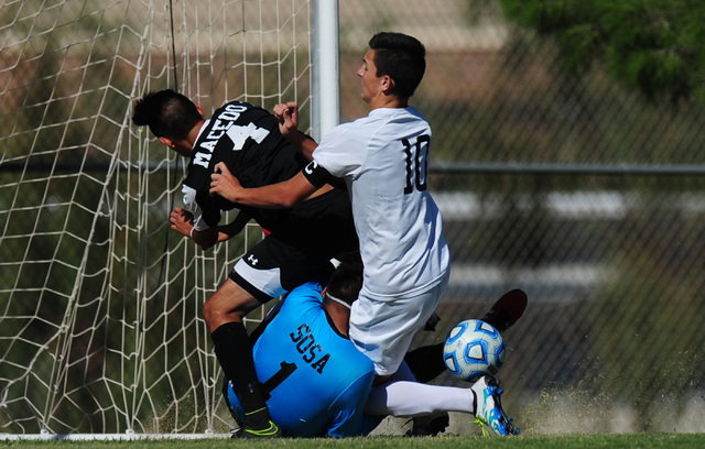 Las Vegas goalkeeper Chris Sosa collides with Coronado striker Preston Judd (10) and Jonatha ...