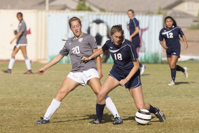 Centennial’s McKenna Stratton (18) fights for the ball with Arbor View’s Allyssa ...