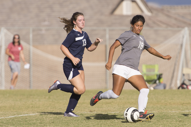 Arbor View’s Madi Boyd (18) dribbles the ball past Centennial’s Shannon Hutchins ...