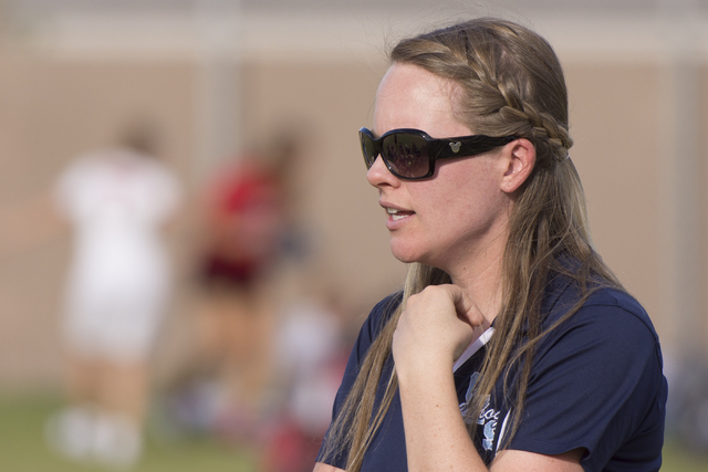 Centennial’s girls soccer head coach Kristina Kasten speaks with her team at halftime ...