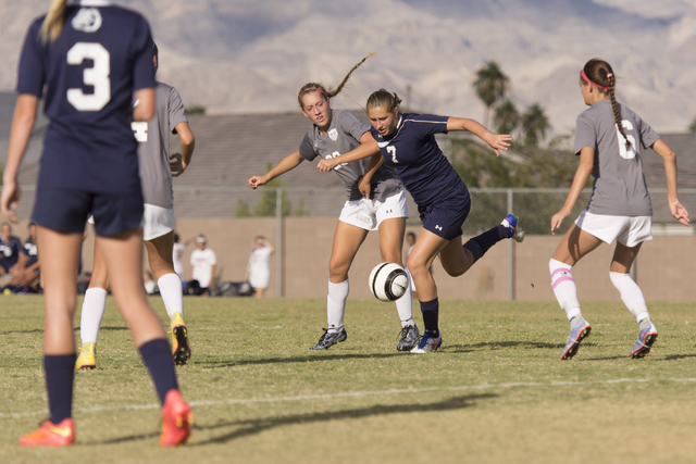 Centennial’s Marcella Brooks (7) fights for the ball with Arbor View’s Allyssa L ...
