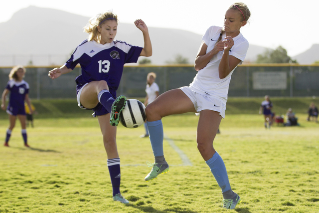Silverado’s Haley Meyer (13), left, fights for ball possession against Foothill’ ...