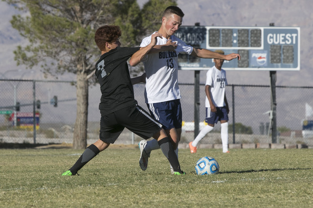 Centennial’s Tyler Rogge (13) is pressured by Cimarron-Memorial’s Kevin Andrade ...