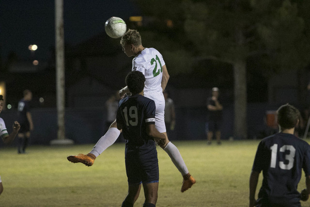 Green Valley forward Cole Aronson (21) connects with a header over Foothill’s Kyle Tho ...