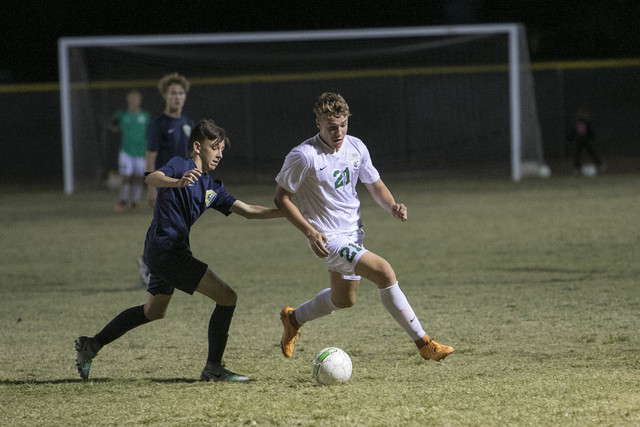 Green Valley forward Cole Aronson (21) is pressured by Foothill’s Kade Killian during ...
