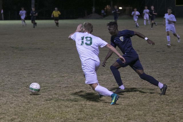 Green Valley midfielder Alessandro Sanchez (19) and Foothill’s Reagan Mugume vie for ...