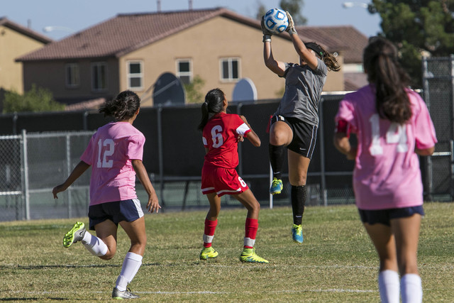 Cheyenne goalkeeper Shayna Thompson jumps to blocks a shot from a Western player during a va ...
