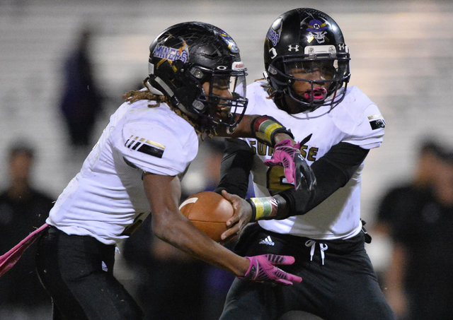 Sunrise Mountain quarterback Stephen Wright (6) hands the ball off to Tayvon Ward (2) during ...