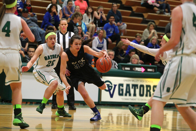 Basic’s Happy Butler (33) pushes past Green Valley’s Rianna Rudolph (20) on Tues ...