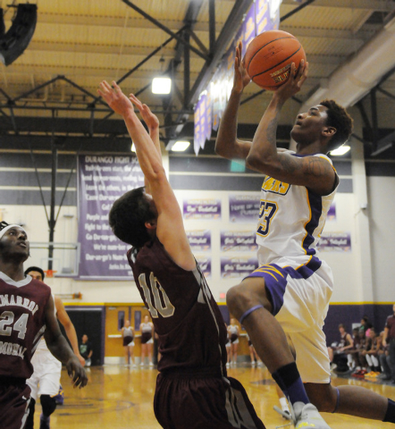 Durango’s Vee Price (23) leaps for a shot over Cimarron-Memorial’s Austin Garris ...