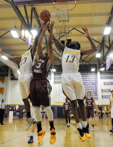 Cimarron-Memorial’s Derek Morefield (33) takes a shot over Durango defenders Darryl Ga ...