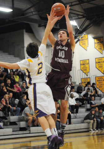 Cimarron-Memorial’s Austin Garrison (10) takes a shot over Durango’s Alex Tarkan ...