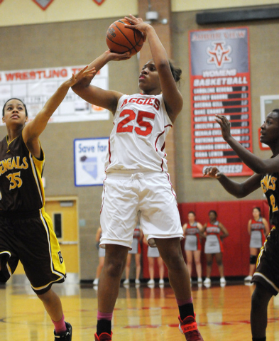 Arbor View’s Dana Lewis (25) takes a shot over Bonanza’s Alexis Harris (35) and ...