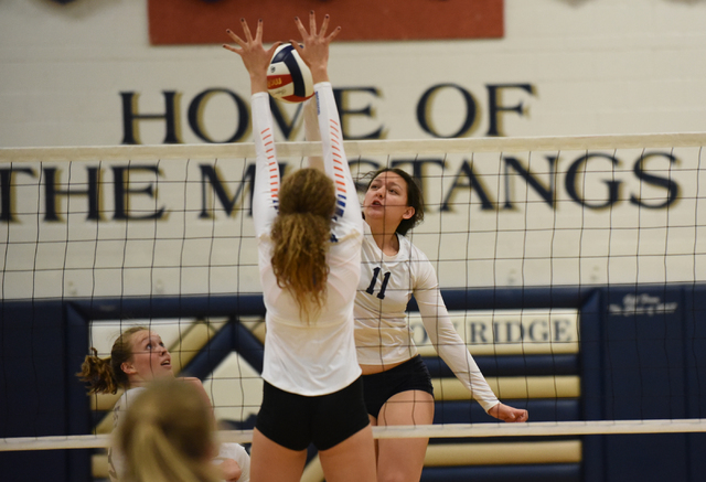 Shadow Ridge’s Natalie Nihipali (11) spikes the ball against a Bishop Gorman defender ...