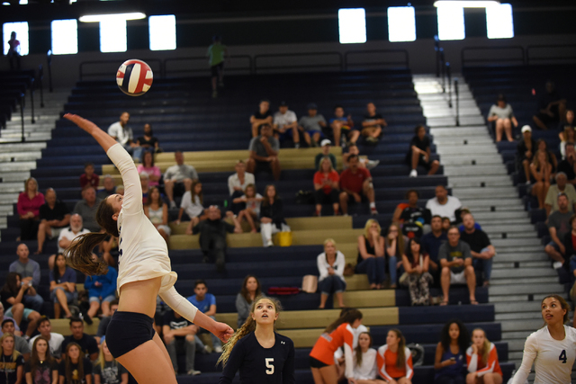 Shadow Ridge’s Whittnee Nihipali (15) spikes the ball against Bishop Gorman defenders ...