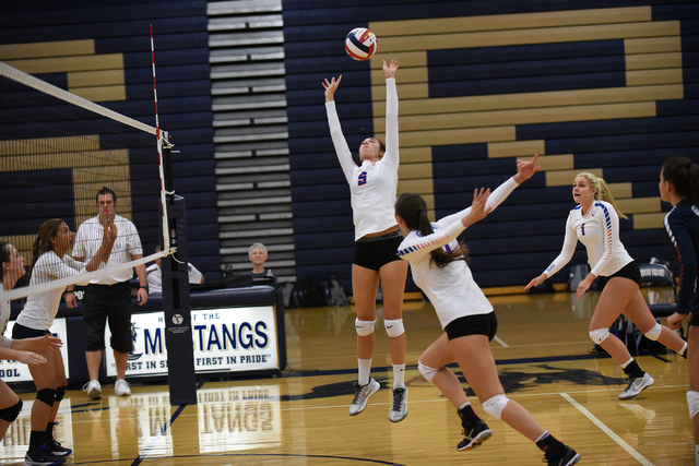 Bishop Gorman’s Kara Hamrick (5), center, sets the ball against Shadow Ridge during th ...