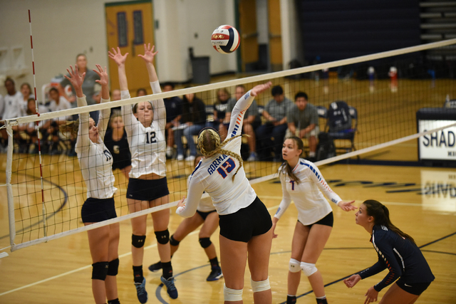 Bishop Gorman’s Abby Archambault (13) spikes the ball against Shadow Ridge’s def ...