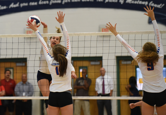 Shadow Ridge’s Stacy Hone (10) spikes the ball against Bishop Gorman defenders from le ...