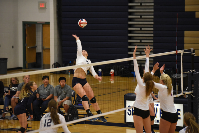 Shadow Ridge’s Whittnee Nihipali (15) spikes the ball against Bishop Gorman defenders ...