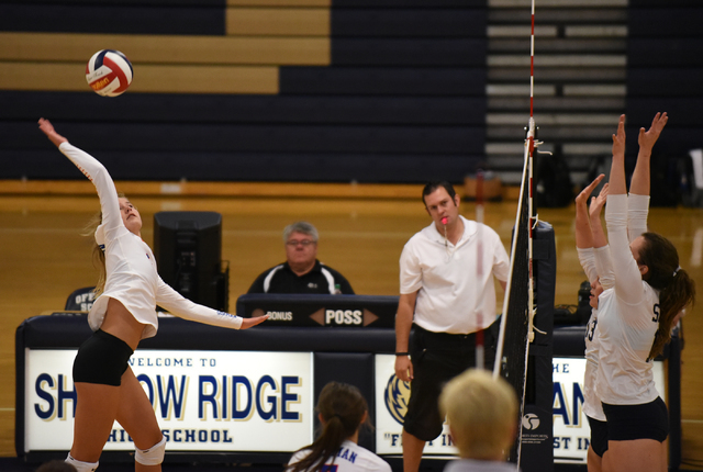Bishop Gorman’s Hannah Karl (4) spikes the ball against Shadow Ridge’s defense d ...