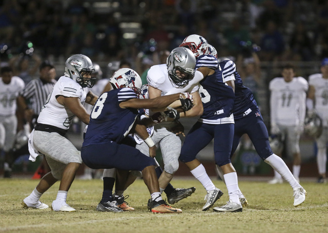 Green Valley wide receiver Jaymz Bischoff (41) is tackled by Liberty defense during a footba ...