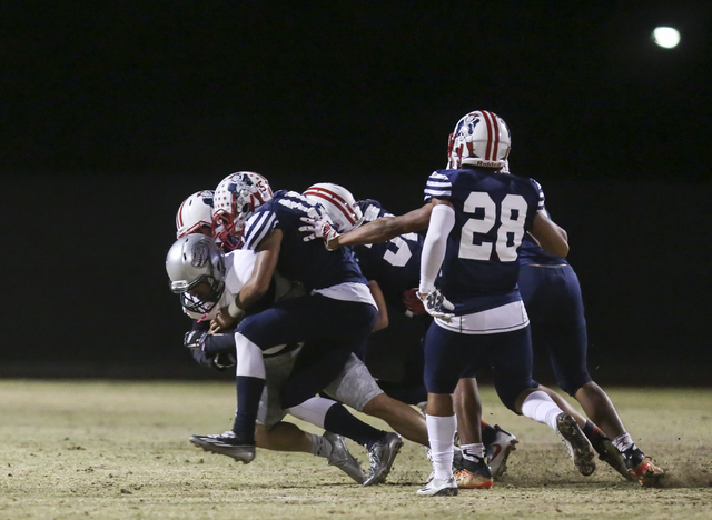 Liberty defense tackles a Green Valley player running the ball during a football game at Lib ...