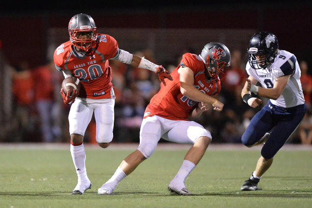 Arbor View quarterback Hayden Bollinger (18) blocks for running back Jaquari Hannie (20) dur ...