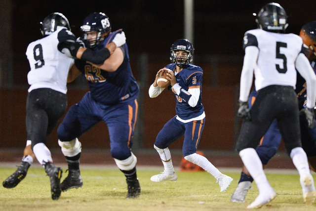 Legacy quarterback Roberto Valenzuela (5) looks for an open receiver during the Legacy High ...