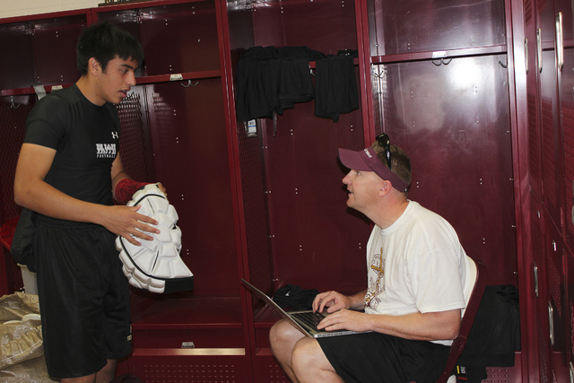 Senior linebacker Johnny Rodgers logs in his Guardian Cap, and other equipment, with Faith L ...