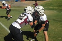 Faith Lutheran’s Akiah Cepielik (32) and AJ Scott (89) go through a drill at the Fresno St ...